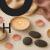 Flat lay of sexual candles surrounded by silk fabrics, rose petals, and massage stones, creating a luxurious and sensual atmosphere for multi-sensory relaxation