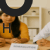 Indian couple consulting female doctor in modern clinic, discussing semaglutide sex drive concerns, with semaglutide information displayed on desk.