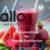 A glass of colorful “erection smoothie” made with watermelon, beetroot, pomegranate, berries, and leafy greens, arranged with fresh ingredients around it to symbolize nutrition and overall sexual health support.